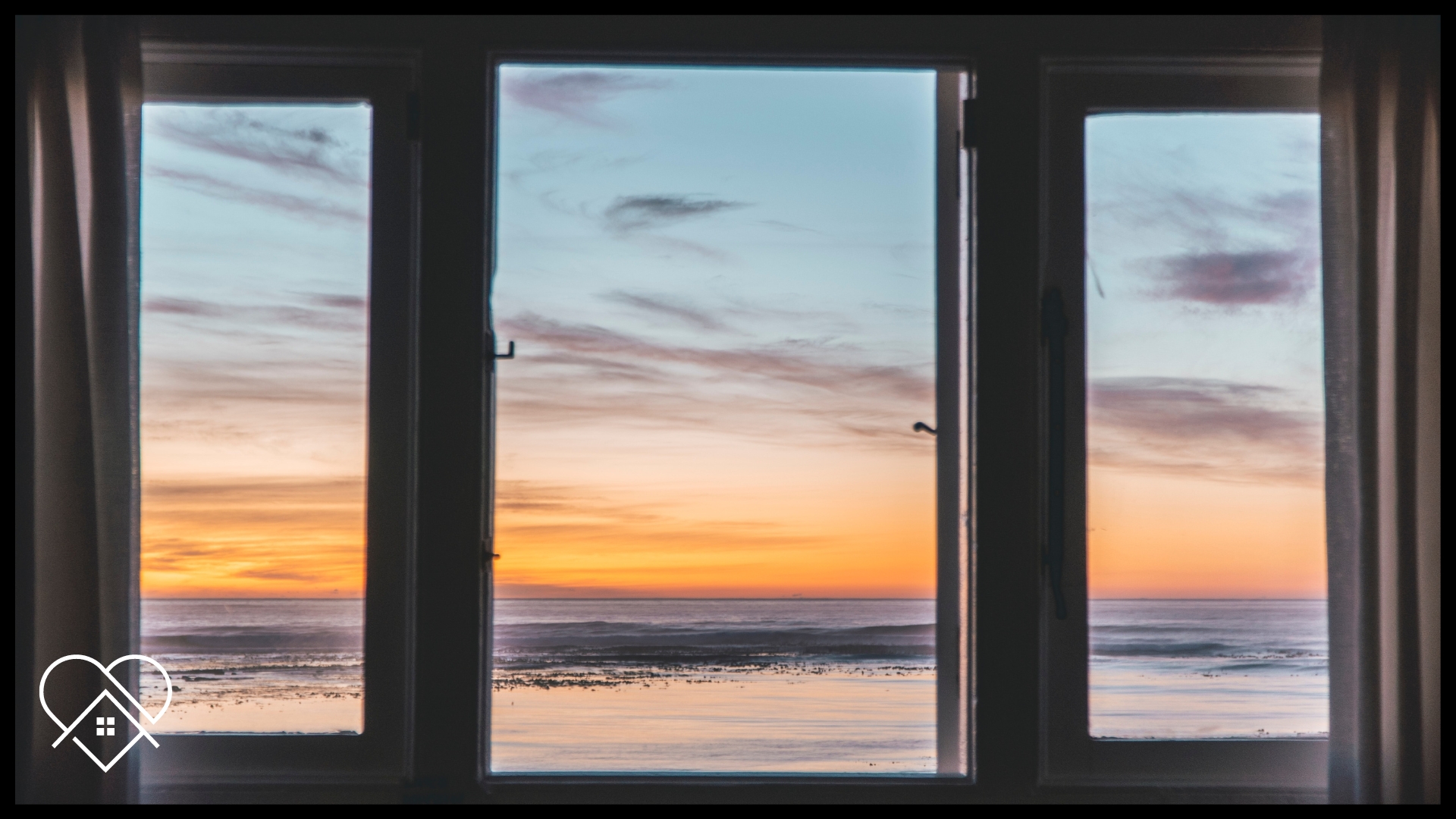 "Window washing service in Nova Scotia: Three clean windows with a beach view."
